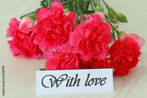 Photo: With love note and pink carnations With love note and pink carnations