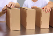 Workers working with boxes at conveyor belt, on grey background