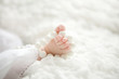 Small baby's feet with beads