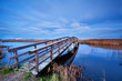 wooden bridge for bicycles over river in dusk