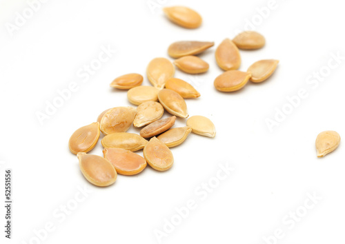 Photo: Pumpkin seeds on a white background. macro Pumpkin seeds on a white background. macro