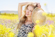 Portrait of young woman in the flowers field
