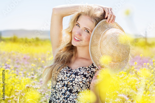 Photo: Portrait of young woman in the flowers field Portrait of young woman in the flowers field