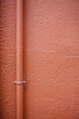 Red wall with pipe