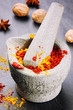 Foto: Mortar with chili pepper and curry powder Mortar with chili pepper and curry powder
