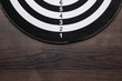 darts target on dark wooden table