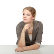Photo: A young woman sitting at the desk, isolated on white background A young woman sitting at the desk, isolated on white background