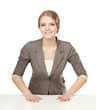 Photo: A young woman sitting at the desk, isolated on white background A young woman sitting at the desk, isolated on white background