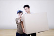 Asian couple bring box to new house