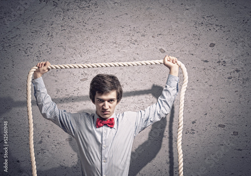 Photo: Businessman holding rope Businessman holding rope