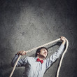 Businessman holding rope