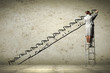 Woman standing on ladder drawing on wall