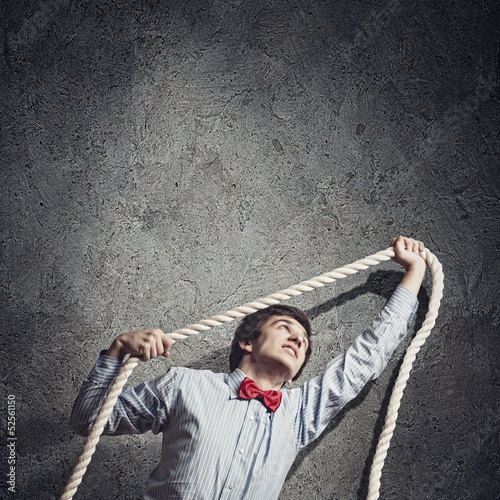 Photo: Businessman holding rope Businessman holding rope
