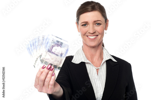 Photo: Corprorate woman holding currency notes Corprorate woman holding currency notes