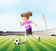 A young girl playing soccer at the field