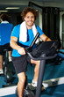 Photo: Fitness man riding a static bike inside gym Fitness man riding a static bike inside gym