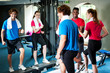 Photo: Couple with personal fitness trainer in the gym Couple with personal fitness trainer in the gym
