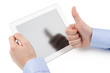 Man's hand holding a tablet computer and the other hand showing