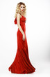 Luxury. Elegant Lady in Red Satiny Dress. Frizzy Blond Hair