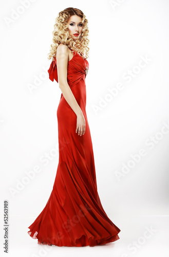 Photo: Luxury. Elegant Lady in Red Satiny Dress. Frizzy Blond Hair Luxury. Elegant Lady in Red Satiny Dress. Frizzy Blond Hair