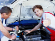 Foto: Apprentices for car mechanic is satisfied with his job Apprentices for car mechanic is satisfied with his job