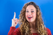 Photo: Beautiful Young Woman on Blue Background Beautiful Young Woman on Blue Background