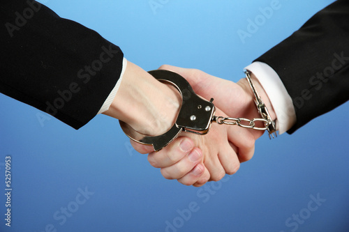 Photo: Man and woman hands and breaking handcuffs on color background Man and woman hands and breaking handcuffs on color background