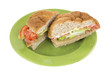 Photo: Tofu turkey sandwich on green plate Tofu turkey sandwich on green plate