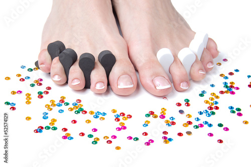 Photo: Womans feet with French pedicure Womans feet with French pedicure