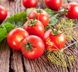 Photo: Tomatoes on the old wooden table. Tomatoes on the old wooden table.