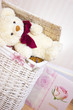 toy bear is sitting on wicker basket