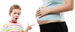 Child boy pointing his pregnant mother abdomen