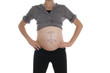 Bauch einer Hochschwangeren mit Aufschrift
