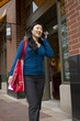 Asian woman walking and talking on her phone