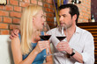 Photo: Attractive couple drinking red wine in restaurant or bar Attractive couple drinking red wine in restaurant or bar