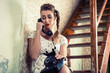 Woman sitting on the stairs and crying on the phone