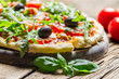 Freshly baked pizza with basil and tomatoes