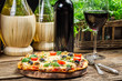 Homemade baked pizza served with wine