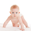 Cute baby with beautiful blue eyes on the white bed