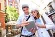 Couple visiting Madrid with help of digital tablet