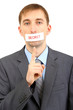Young businessman with a band on his mouth isolated on white