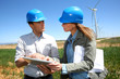 Engineers using tablet on wind turbine site