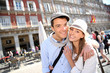 In love couple visiting la Plaza Mayor de Madrid