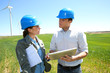 Engineers using tablet on wind turbine site