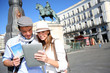 Couple checking on tourist information in Madrid