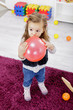 Little girl with balloon in the room
