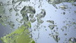 Fresh lime dropped into water with splash
