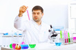 Photo: Young male scientist working in laboratory Young male scientist working in laboratory