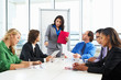 Businesswoman Conducting Meeting In Boardroom