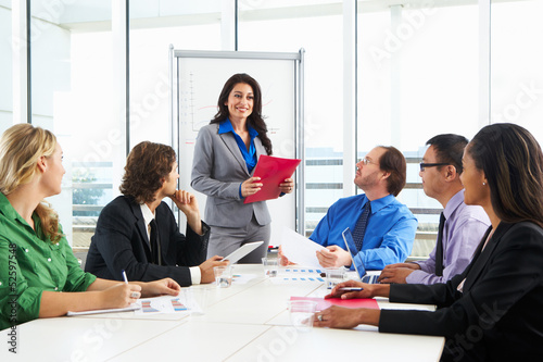 Photo: Businesswoman Conducting Meeting In Boardroom Businesswoman Conducting Meeting In Boardroom